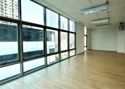 Spacious living room with large windows and wooden flooring