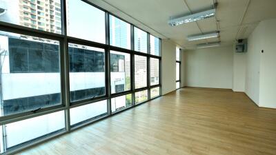 Spacious living room with large windows and wooden flooring