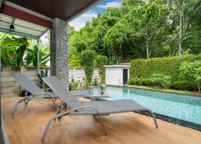 Outdoor pool area with lounge chairs