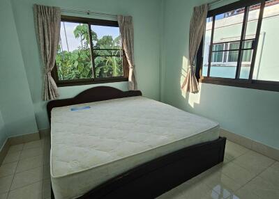 Bright bedroom with windows and double bed