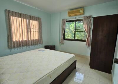 Spacious bedroom with a double bed and large window