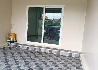 Balcony with sliding glass door and tiled flooring