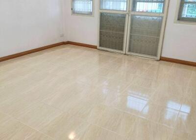 Bright, empty living room with tiled floor