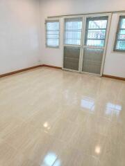 Bright, empty living room with tiled floor