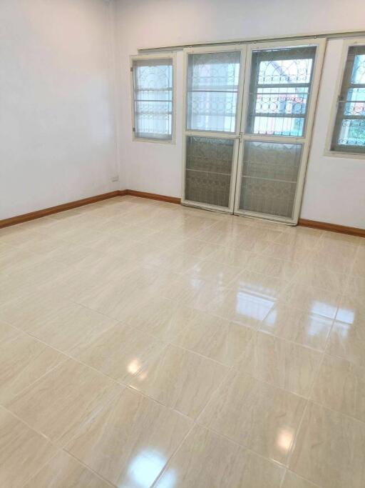 Bright, empty living room with tiled floor