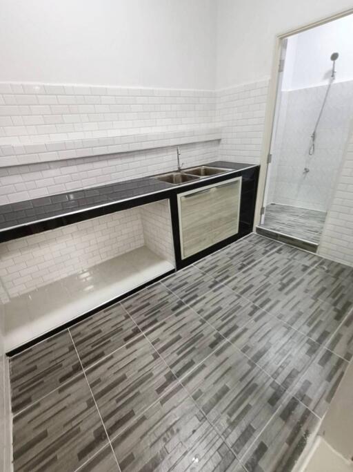 Modern kitchen with tiled flooring and a sleek design