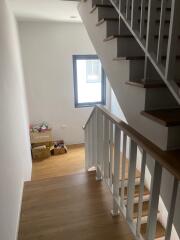 Internal staircase with wooden steps and white railing