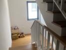 Internal staircase with wooden steps and white railing