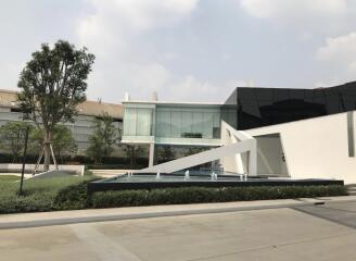 Modern building exterior with glass facade and fountain