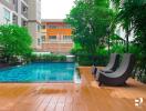 Outdoor swimming pool with deck chairs and surrounding greenery