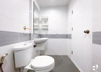 Modern bathroom with white tiles and fixtures