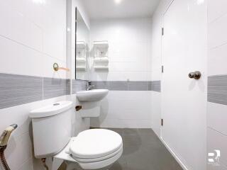 Modern bathroom with white tiles and fixtures