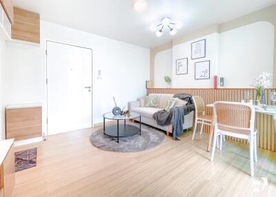 Modern and bright living room with a sofa, table, chairs, and wall decor