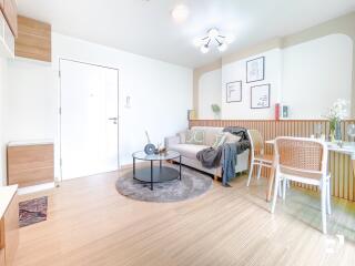 Modern and bright living room with a sofa, table, chairs, and wall decor