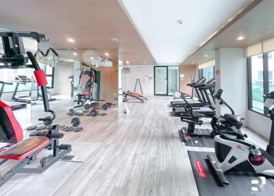 Modern gym with exercise equipment and mirrored walls