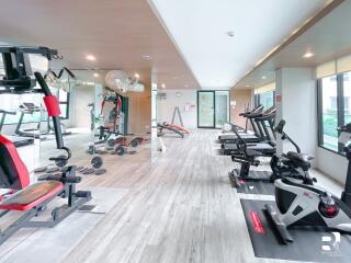 Modern gym with exercise equipment and mirrored walls