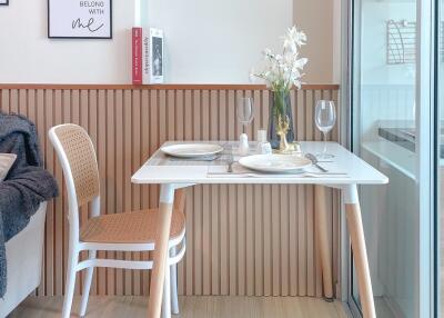 Small dining area with a table set for two next to a window