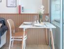 Small dining area with a table set for two next to a window