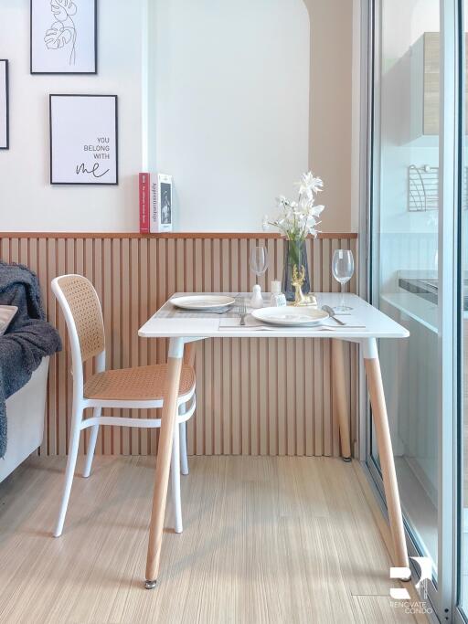 Small dining area with a table set for two next to a window