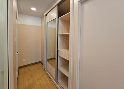 Spacious closet with wooden flooring and built-in storage