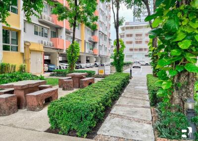 pathway and outdoor seating area next to residential building