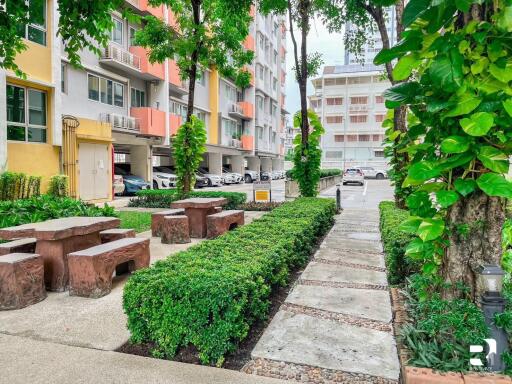 pathway and outdoor seating area next to residential building