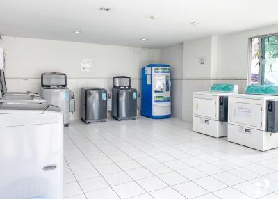 Spacious laundry room with multiple washers and dryers