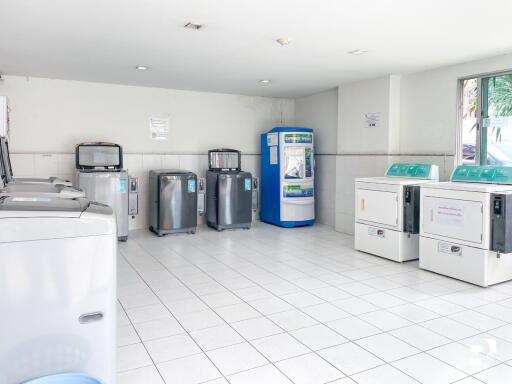 Spacious laundry room with multiple washers and dryers