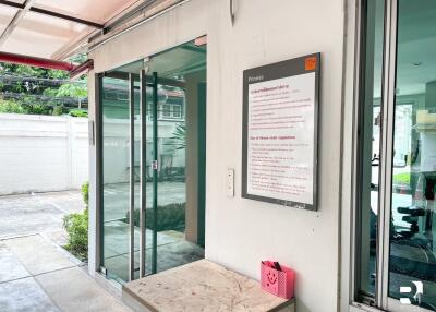 Gym entrance with glass doors and fitness sign