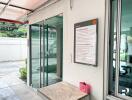 Gym entrance with glass doors and fitness sign