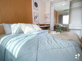 Modern bedroom with cozy bed and mirrored wardrobe