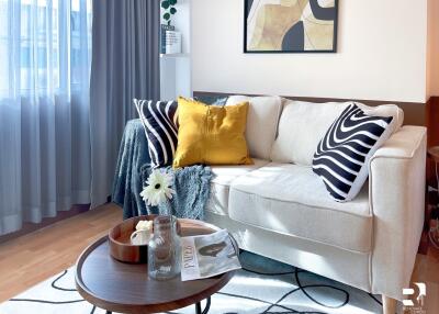 Cozy living room with a comfortable sofa, decorative pillows, and a coffee table.