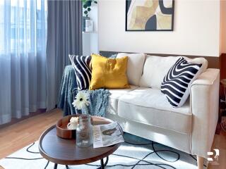 Cozy living room with a comfortable sofa, decorative pillows, and a coffee table.