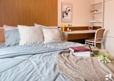 Cozy bedroom with a neatly made bed and a study desk