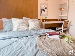 Cozy bedroom with a neatly made bed and a study desk