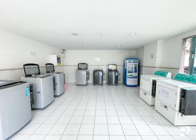 Laundry room with multiple washing machines