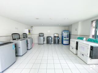 Laundry room with multiple washing machines