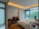 Spacious bedroom with a large window and modern furnishings