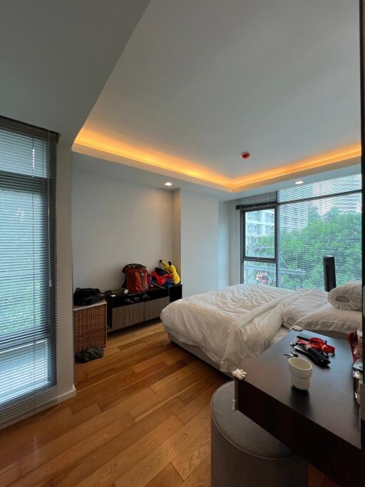 Spacious bedroom with a large window and modern furnishings