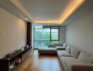 Modern living room with wooden floor and large windows