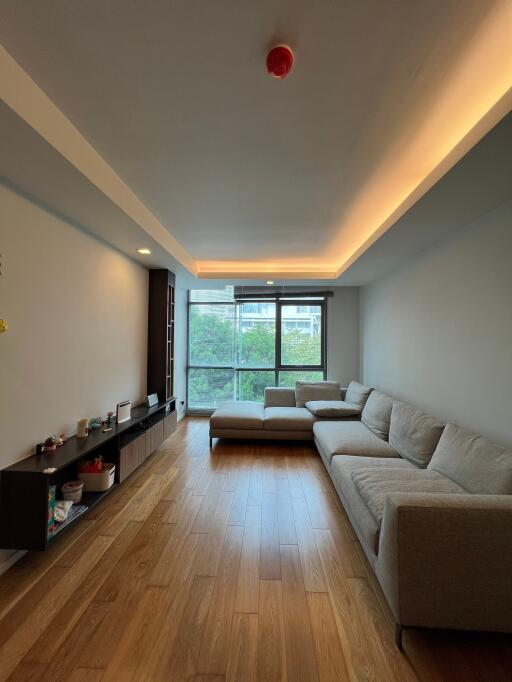 Modern living room with wooden floor and large windows