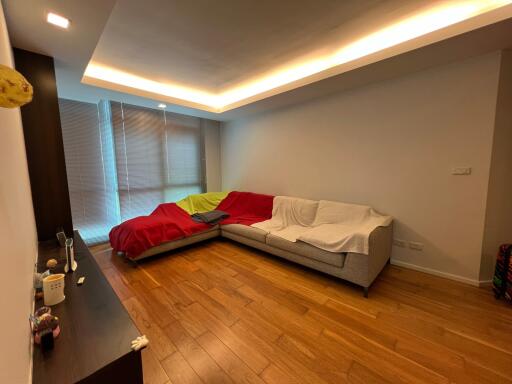 Modern living room with L-shaped sofa and wooden flooring