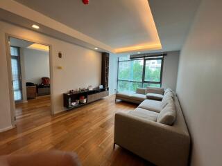 Modern living room with wooden flooring and large windows