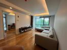 Modern living room with wooden flooring and large windows