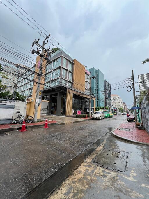 Exterior view of the property building with adjacent street and parked vehicles