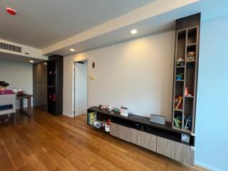 Modern living room with built-in shelving and hardwood floors