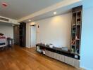 Modern living room with built-in shelving and hardwood floors