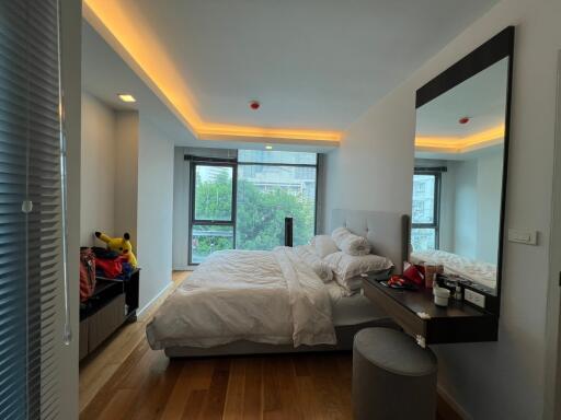 Modern bedroom with large windows and ambient lighting