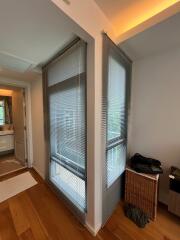 Bedroom with large windows and blinds