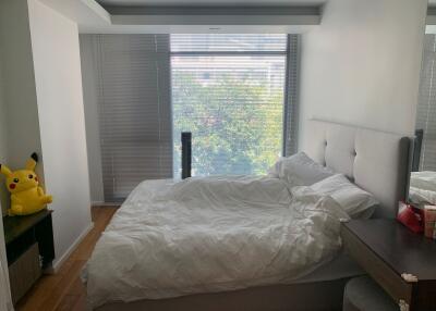 Bedroom with large window and double bed